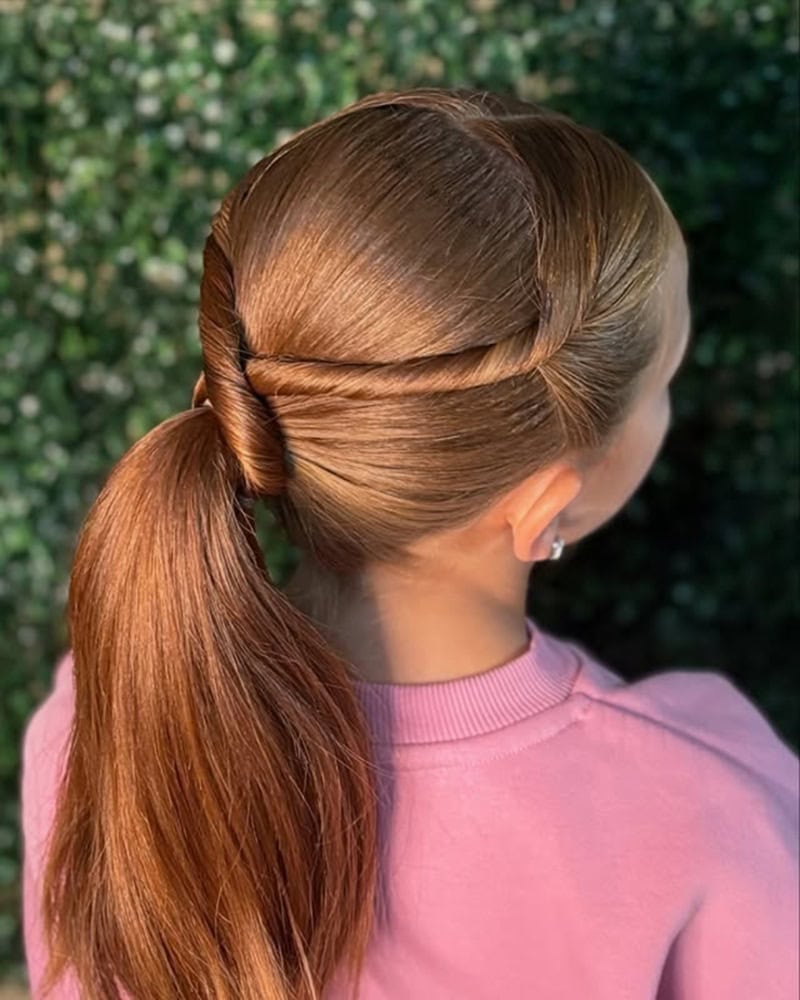 10 year old girl with a low, twisted ponytail hairstyle.