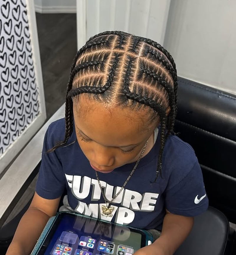 11-year-old boy with braided hairstyle featuring intricate cornrows and geometric parts