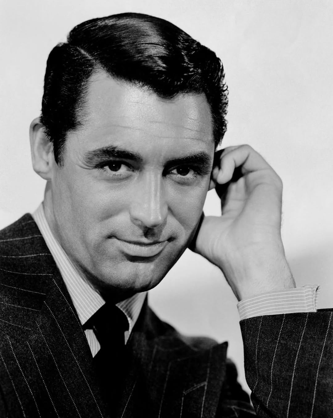 vintage slicked side part classic 1950s male hairstyle