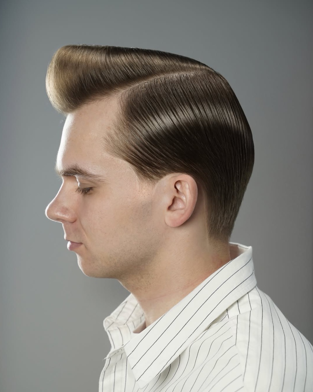 ultra neat 1950s executive side-part pompadour on light brown hair with high front volume