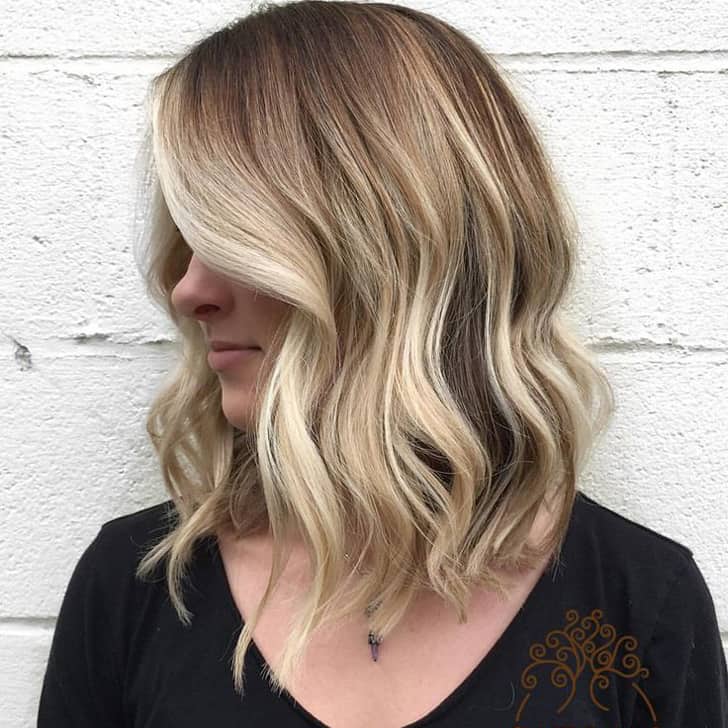 Long Blonde Waves Grazing the Shoulders