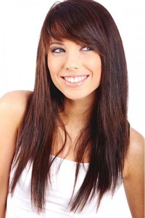 assymetrical long layered hair with side swept bangs for young women