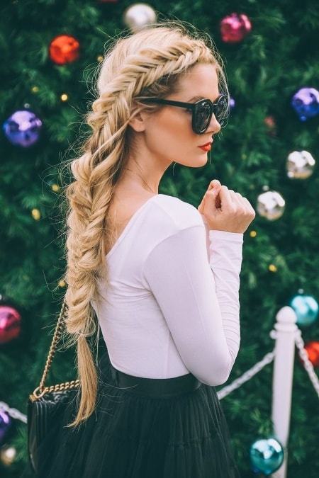 Fishtail and weave hairstyle with sunglass by a girl