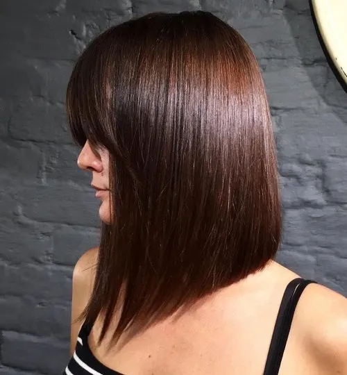 Sleek Heavy Bangs hairstyle with auburn hair