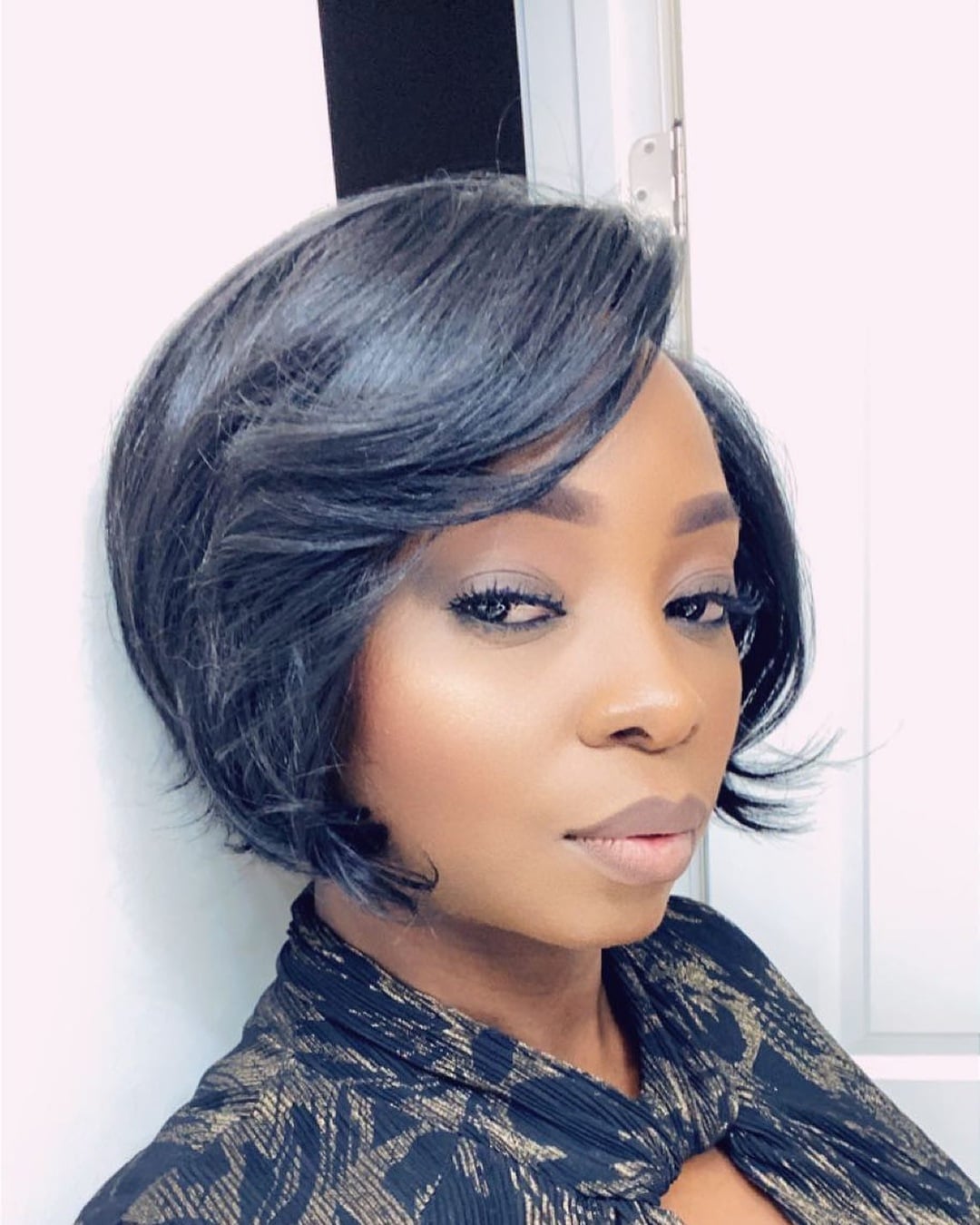 Sleek side-swept 27 piece bob hairstyle with layered ends