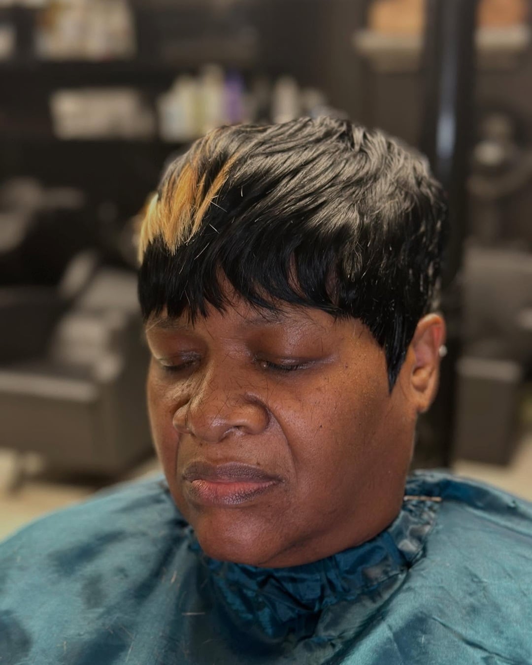 Textured 27 piece pixie cut with blonde peekaboo bang highlights