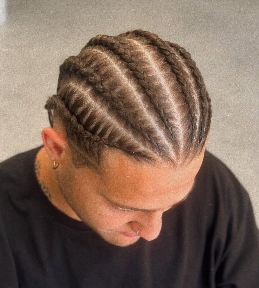 Top view of a white man with light brown straight hair styled into six clean stitch cornrow braids.