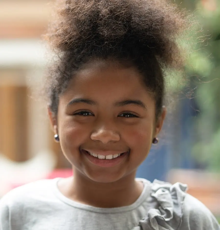 8 year old black girl with afro puff hairstyle