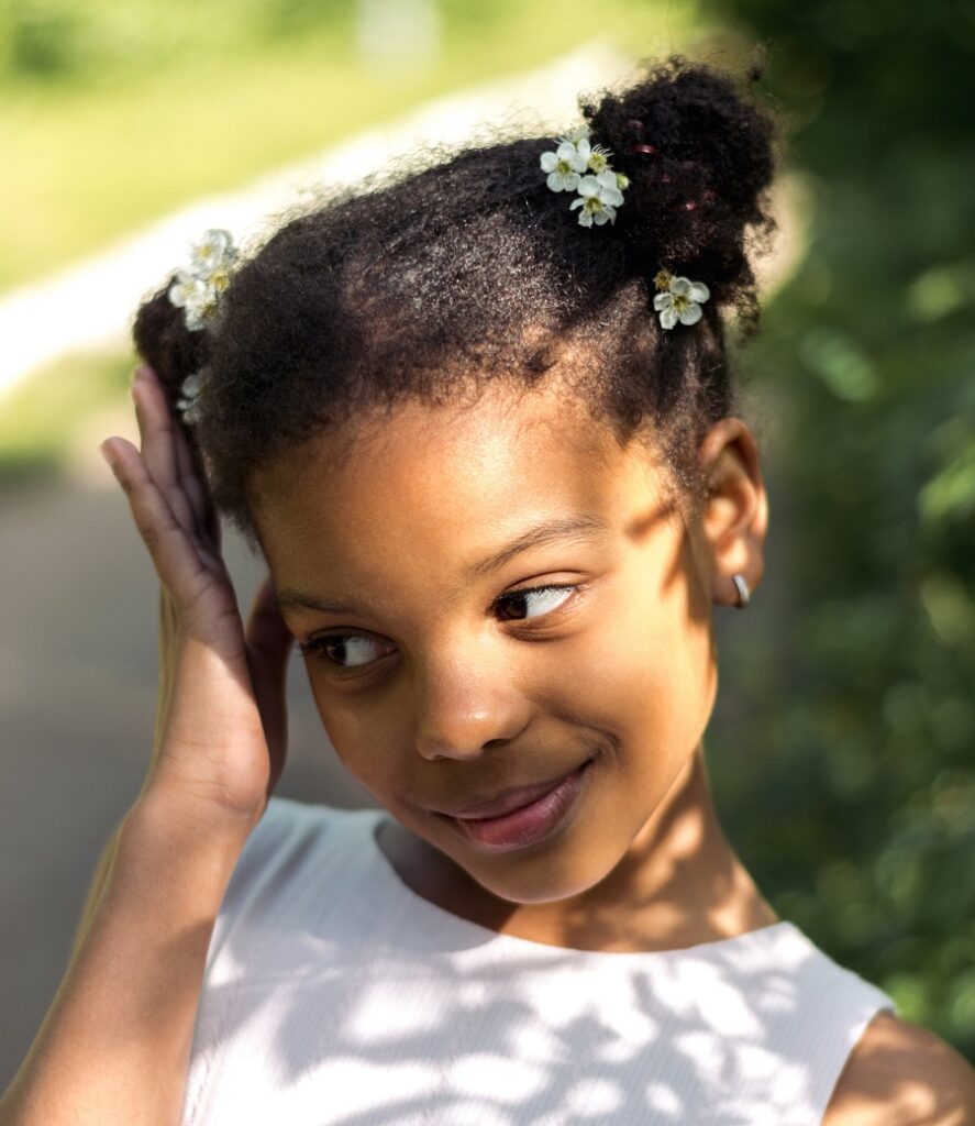8 year old black girl with space buns hairstyle