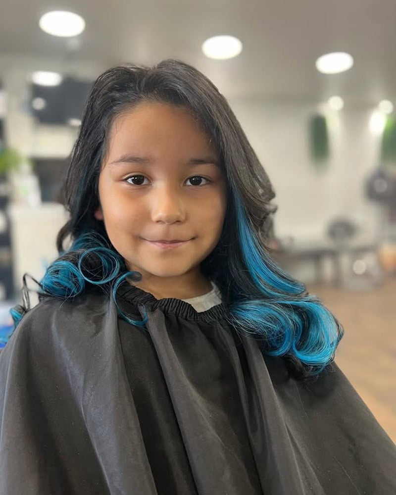 9 year old girl with long dark hair featuring bright blue highlights