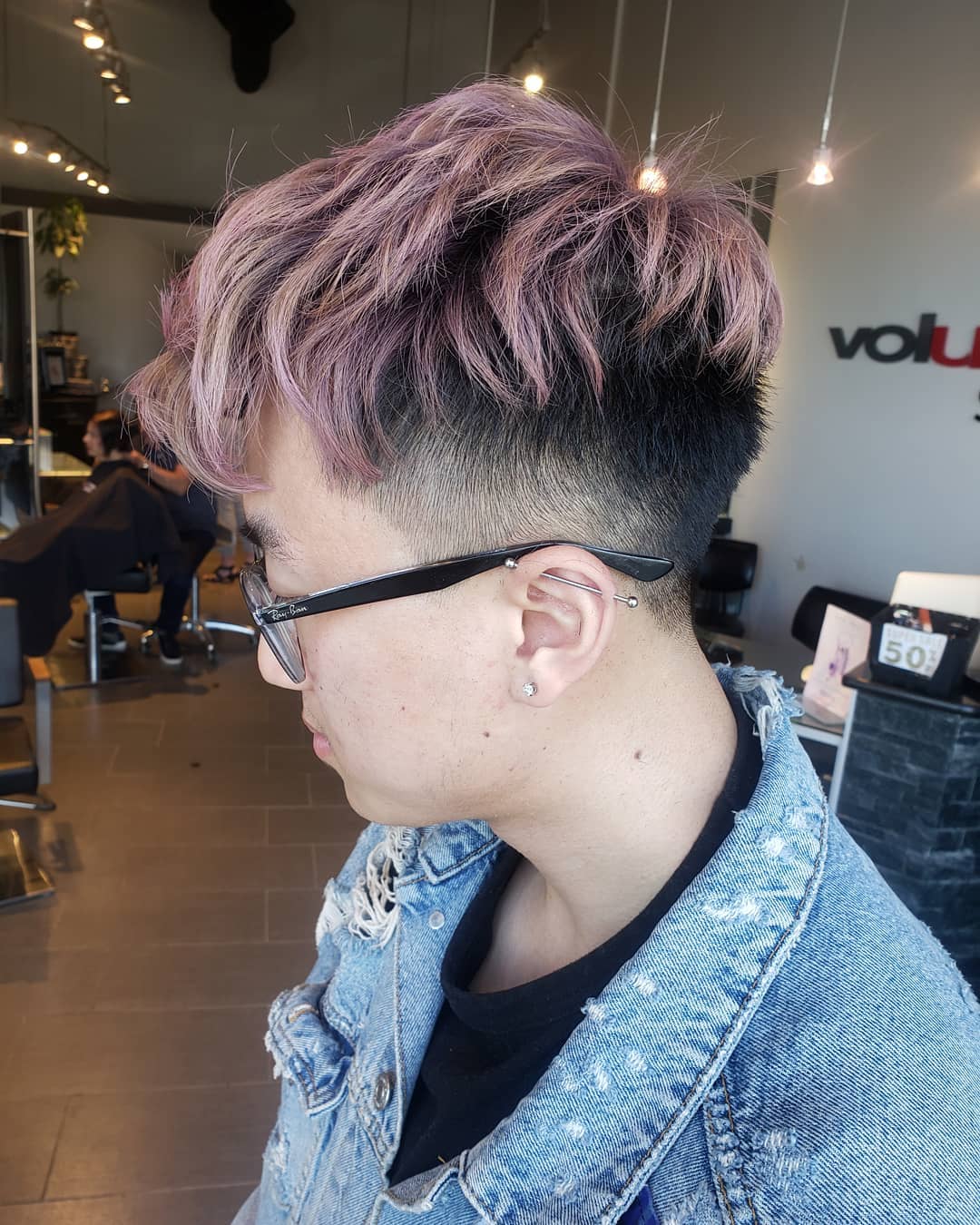 Asian boy haircut featuring a messy textured dusty pink top with a dark undercut