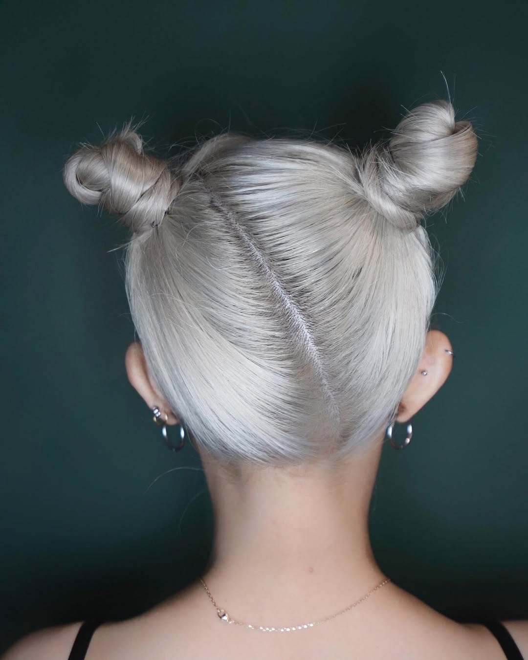 Back view of Asian woman with creamy blonde hair in space buns