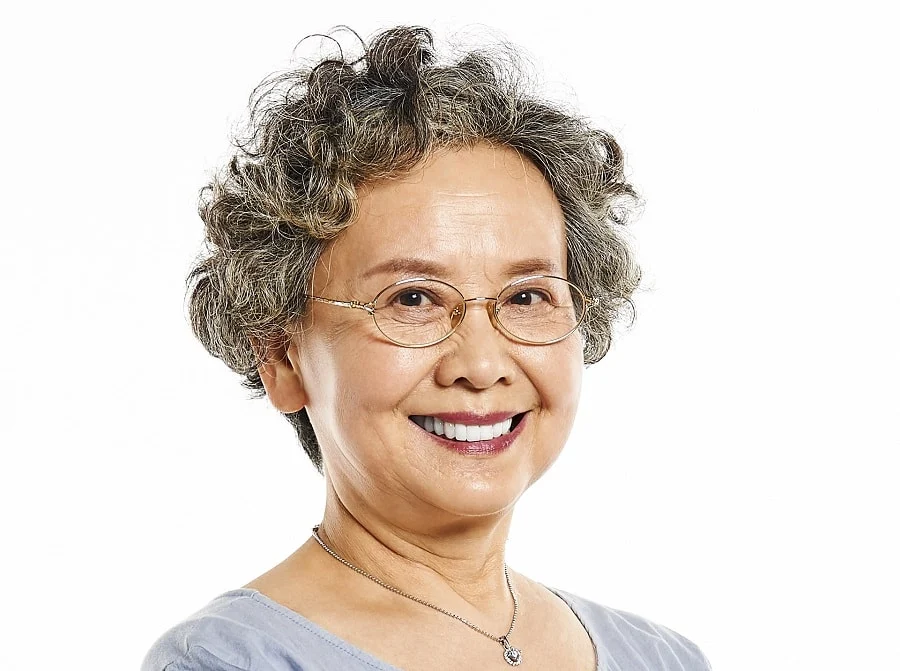 Asian woman over 50 with short perm hair