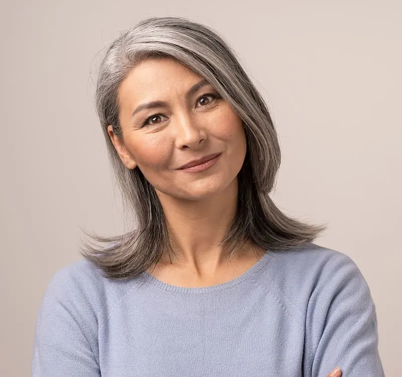 Asian woman with grey hair and round face