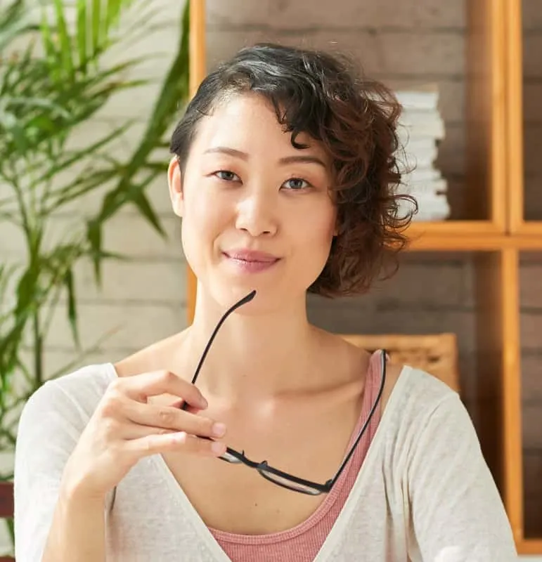 Asian woman with thin curly hair