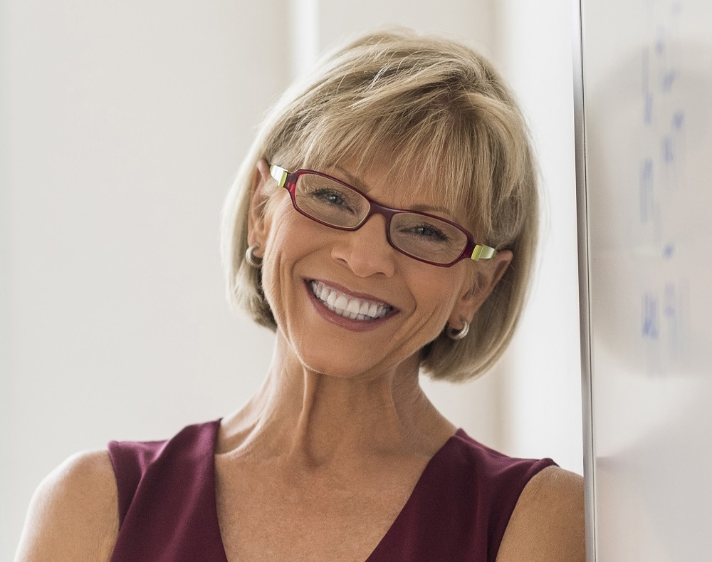 Blonde bob hairstyle for over 60 with glasses