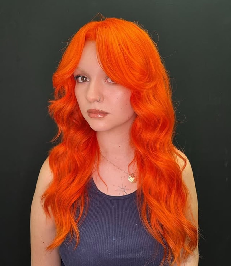 ong, bright vivid orange beach waves with curtain bangs.