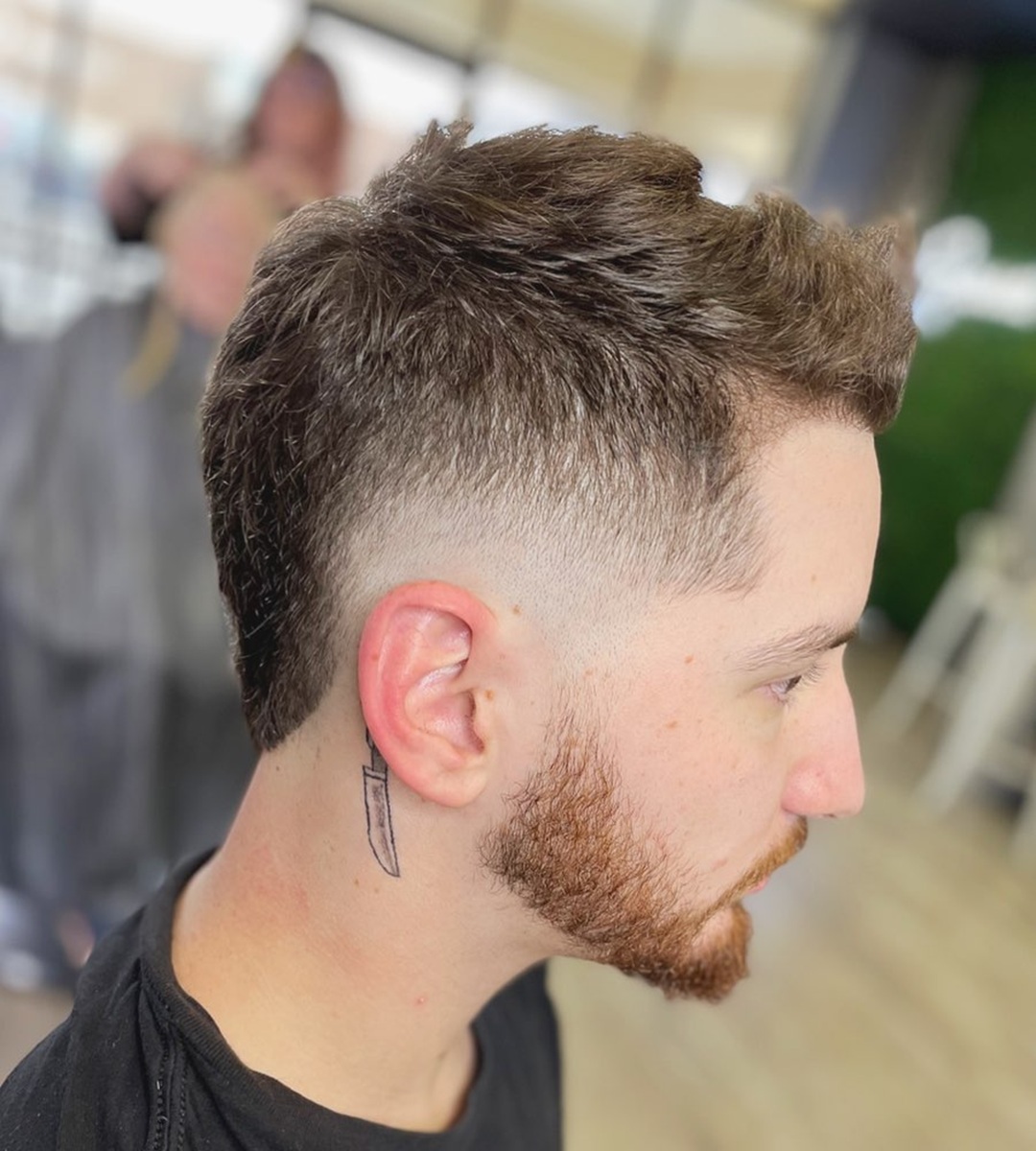 Side view of a Puerto Rican man with a textured burst fade mullet