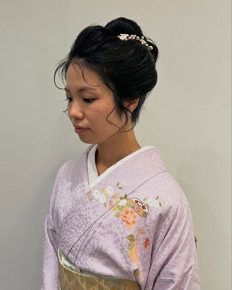 Japanese woman with a high, voluminous bun and pearl hair accessories