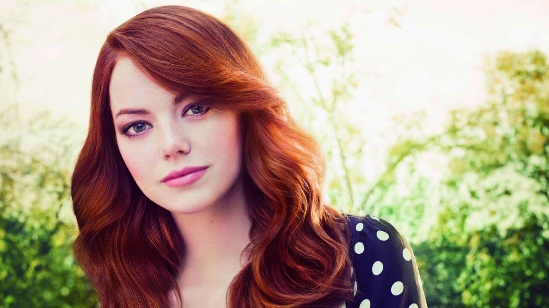 Emma Stones long russet hair that matches her skin tone