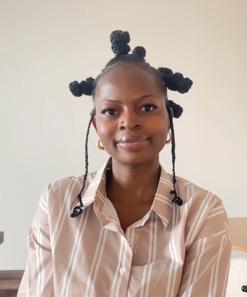 Front view of the finished Bantu knot hairstyle with raised knots, slim side braids, and coiled ends.