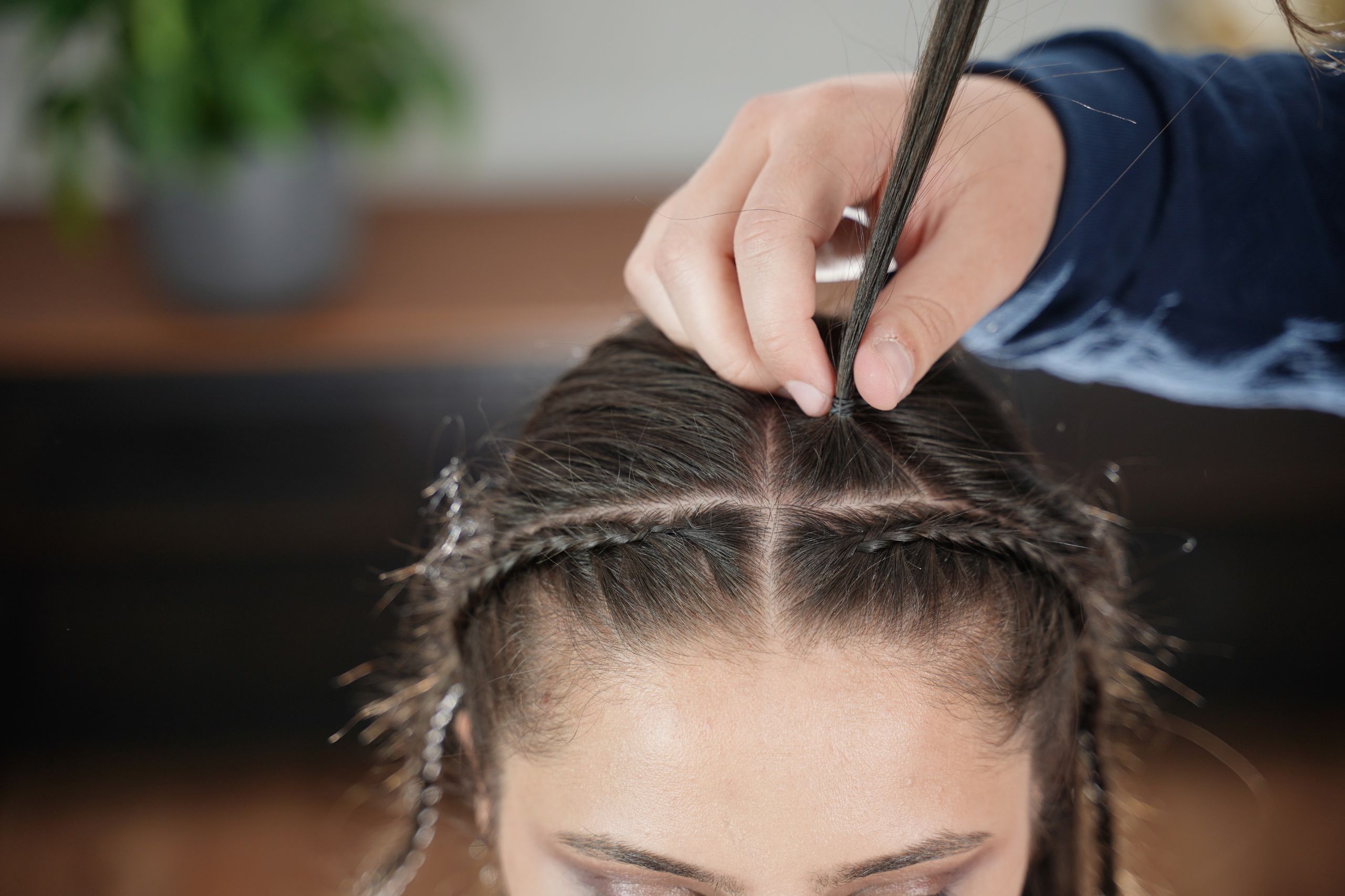 A top center section is lifted to create the first ponytail for the bubble braid.