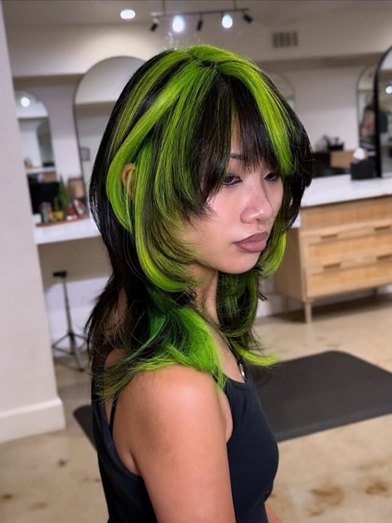 choppy black scene hair with neon green face-framing layers