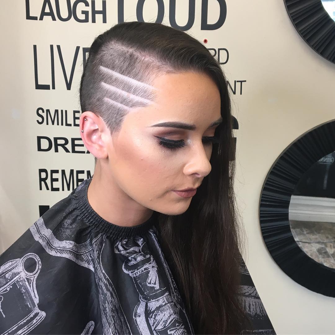 Long dark hair women shaved undercut featuring a side temple design with three shaved lines
