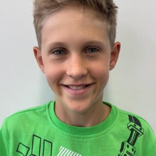 blonde boy long hair styled in messy, textured look with short sides