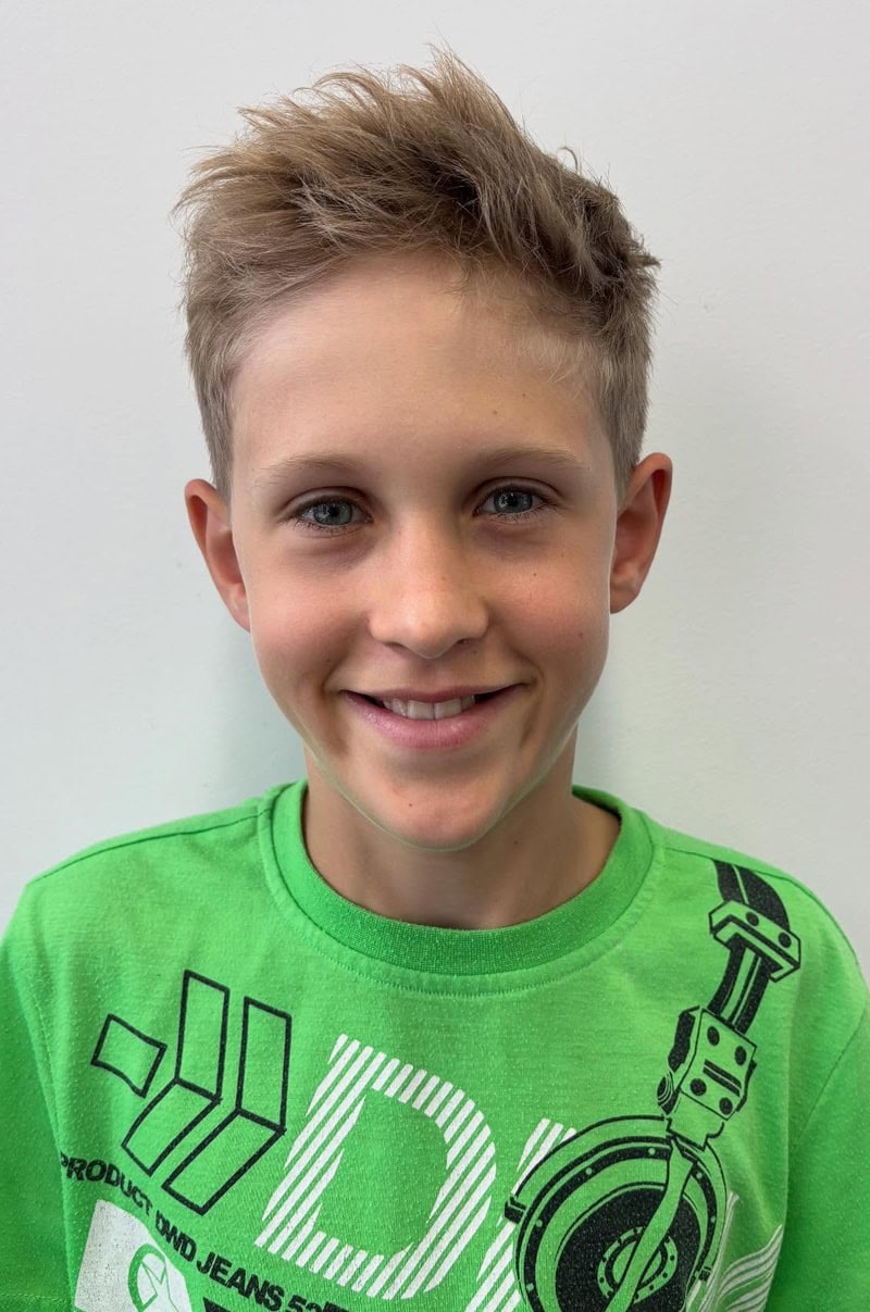 blonde boy long hair styled in messy, textured look with short sides