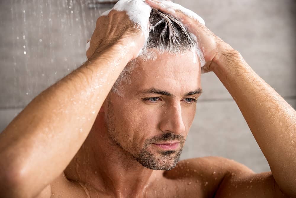 Man washing hair before haircut
