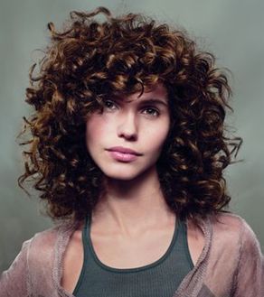 light brown curly hair with bangs