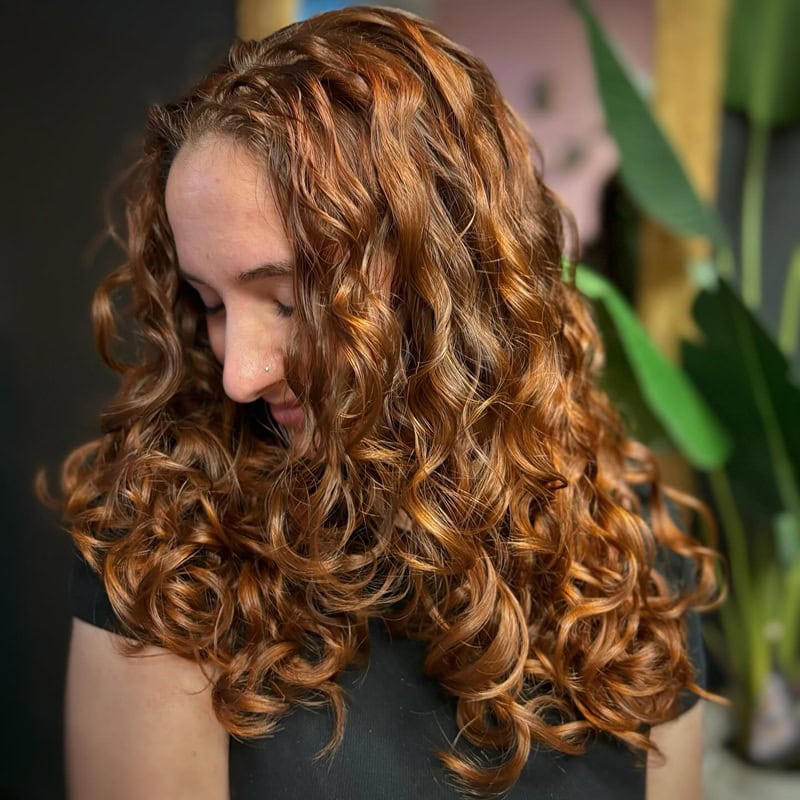 Voluminous curly auburn hair with ringlets