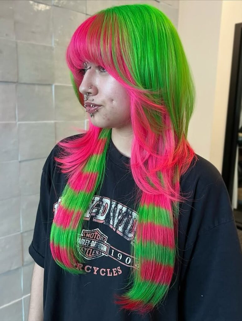 split-dye scene hair featuring neon pink and green coontails