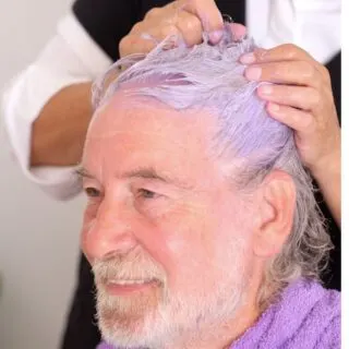 applying purple shampoo on gray hair