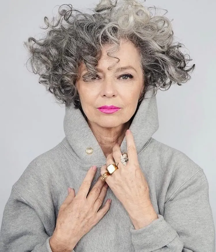 Stylish senior citizen with side-parted black and white hair