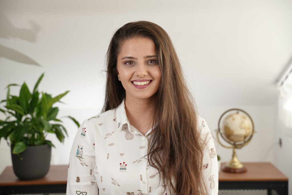 Model with long hair brushed smooth and styled with a soft deep side part.