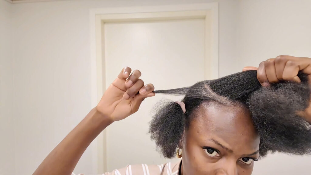 The stylist holds a thin front section beside the C-cut part around the center section.