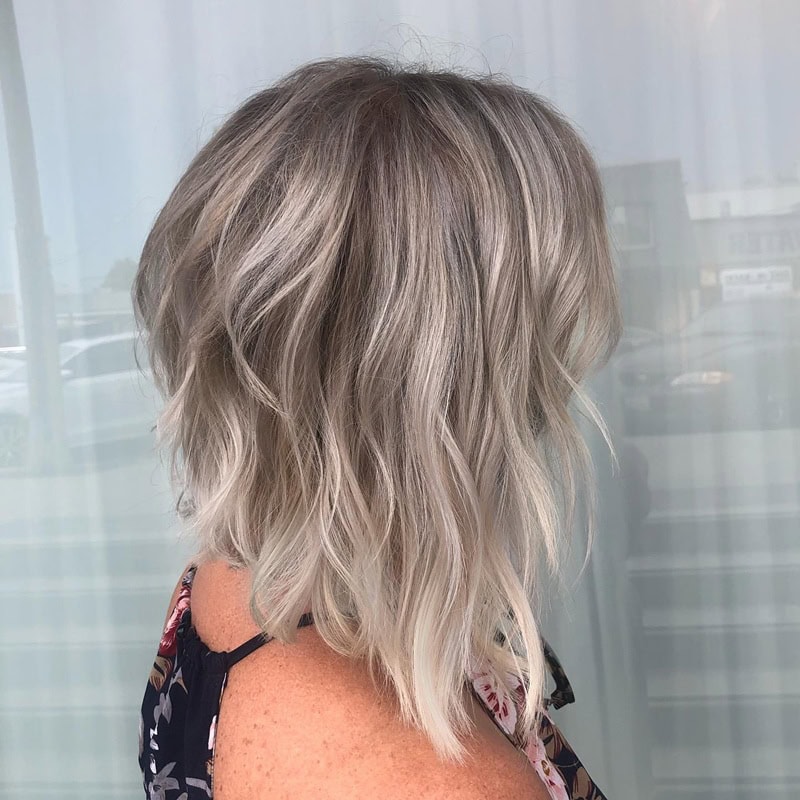 Wavy short bob with cool-toned ash blonde balayage highlights
