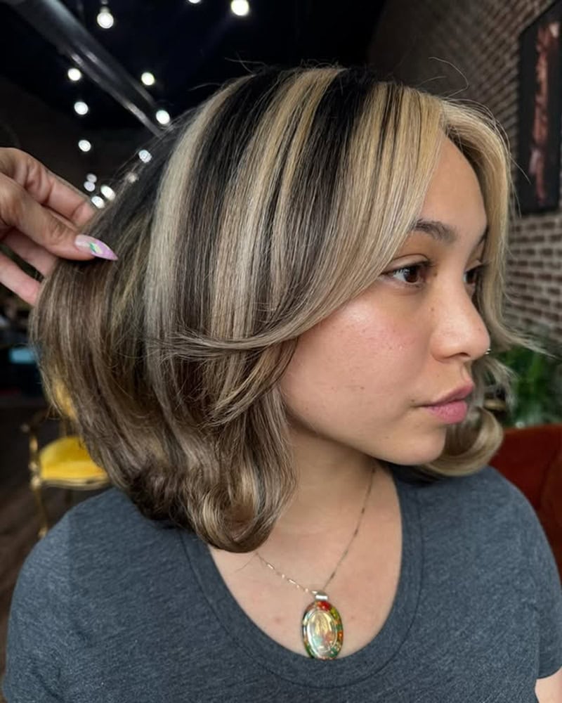 dark brown short bob with bold blonde money piece highlights