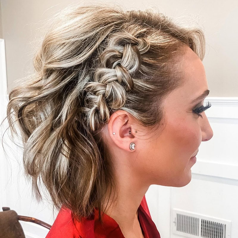 short hairstyle with a side Dutch braid showcasing with blonde highlights on a brunette base