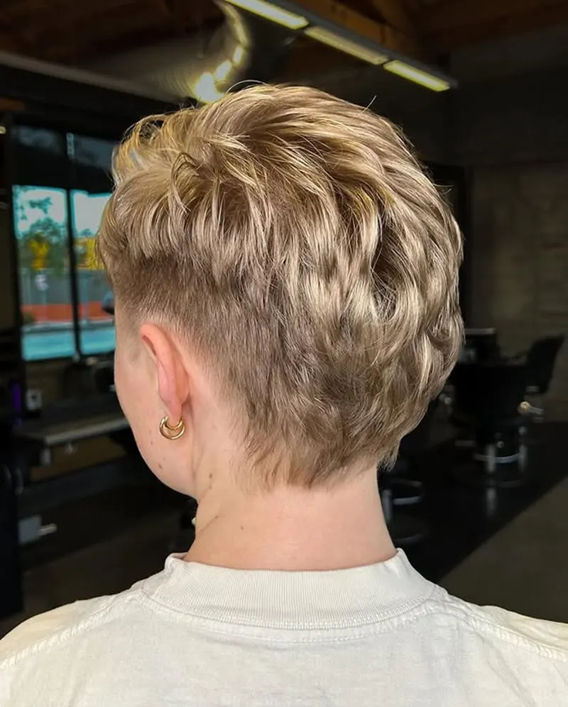 short pixie cut with textured layers and soft blonde highlights