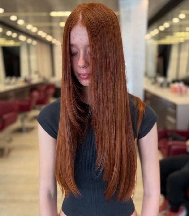 Long straight auburn hair with face-framing layers