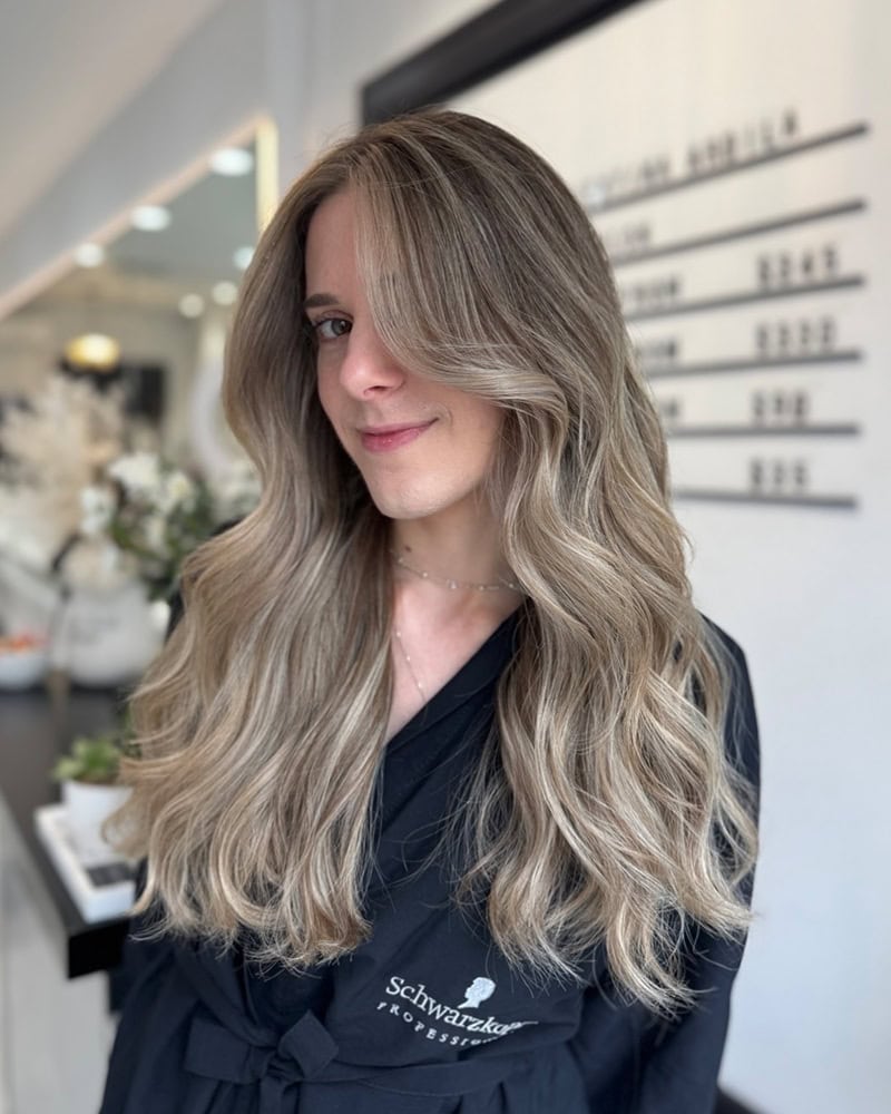 long, wavy hair in soft, ash-toned champagne blonde shade