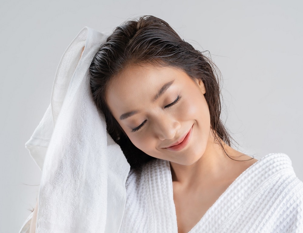 Steps to Blow Dry Your Hair Without Creating Frizz - dry hair with towel