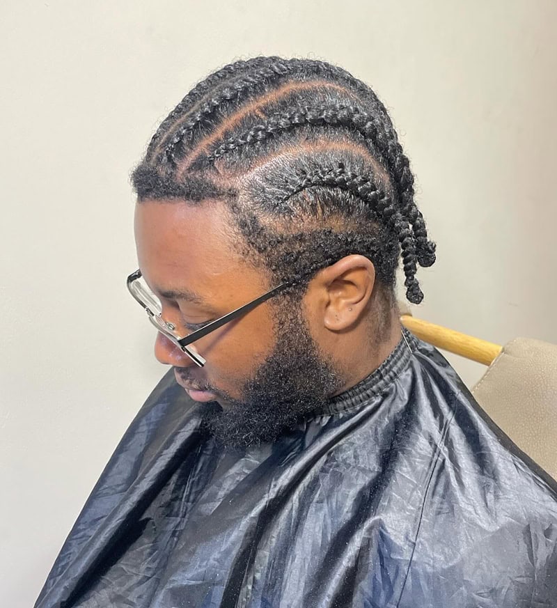 black man with straight-back cornrows with full beard, a protective style for thick hair