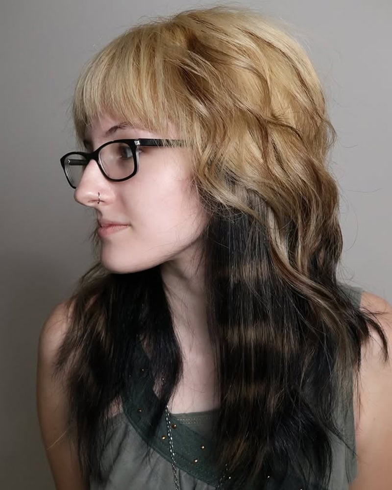 layered blonde scene hair with contrasting black peekaboo panels