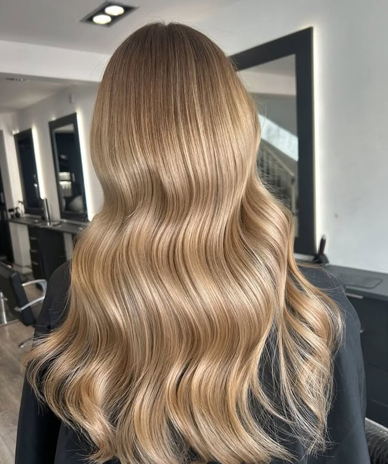 long hair in warm, golden honey blonde balayage shade