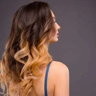 Woman with Long Healthy Colorful Ombre Wavy Hair