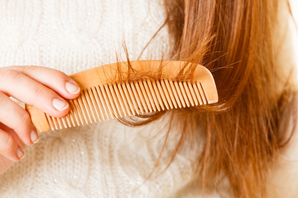 combing hair with wooden comb so it doesn't cause static damage